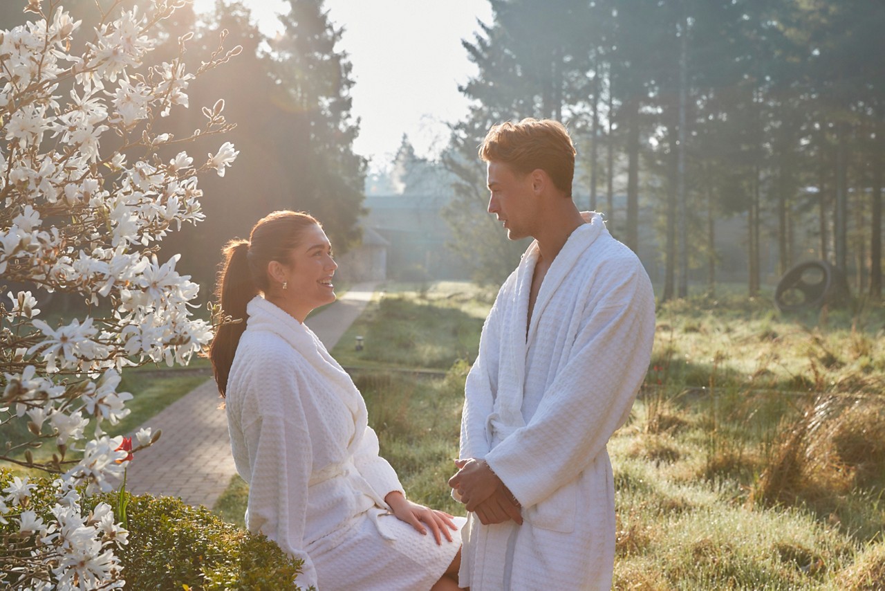 couple in robes by blossom